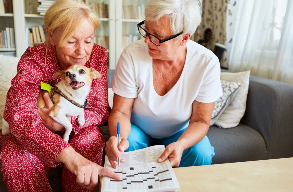 Two women doing a crossword puzzle.