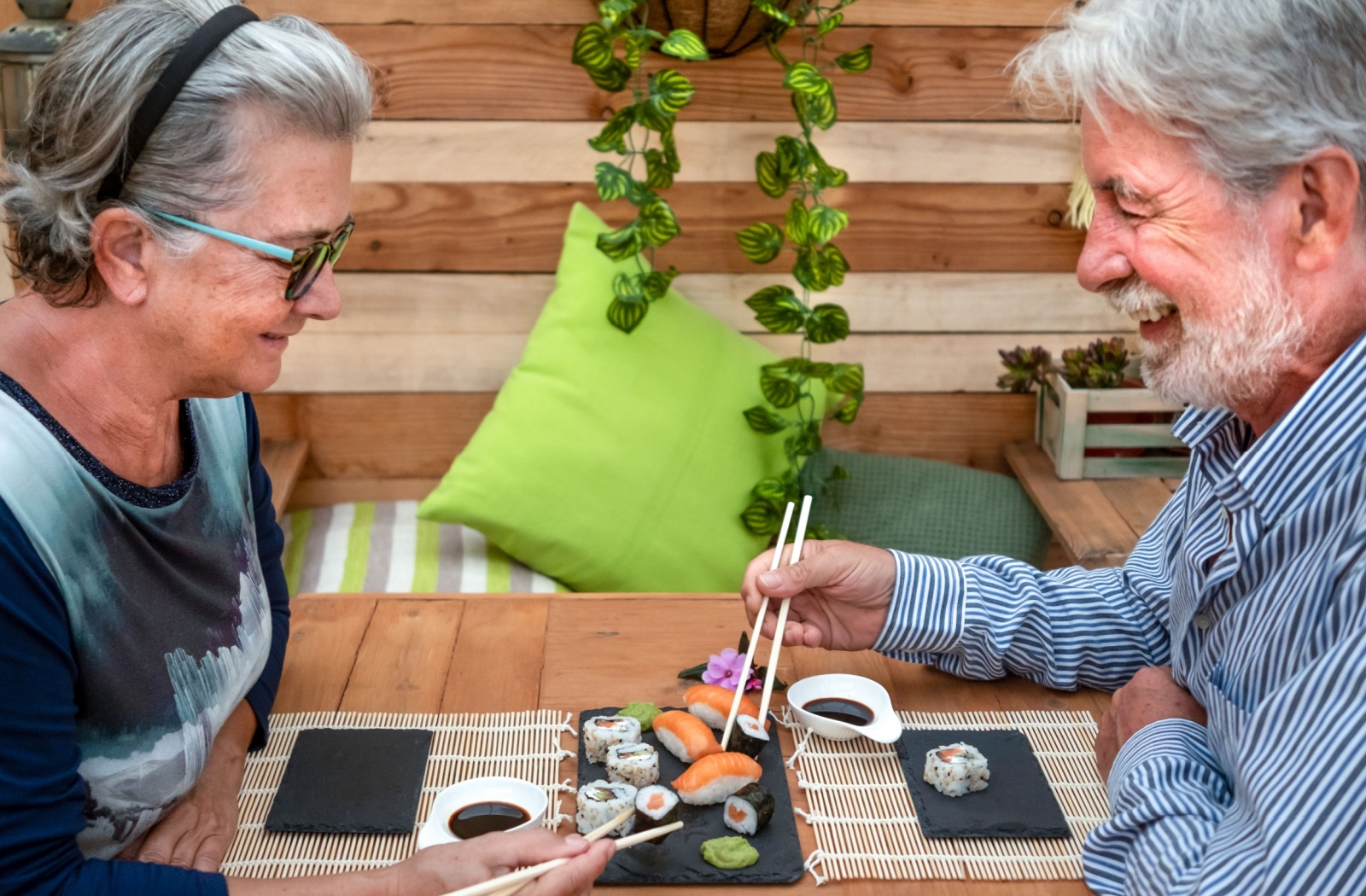 Seniors enjoying omega-3-rich sushi together promoting healthy aging through better nutrition and social engagement.