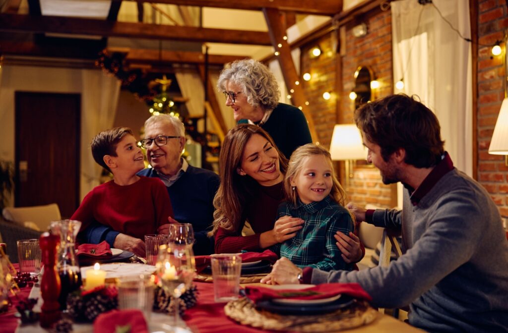 A young nuclear family gathers together with senior parents to celebrate a holiday and connect over food and conversation.