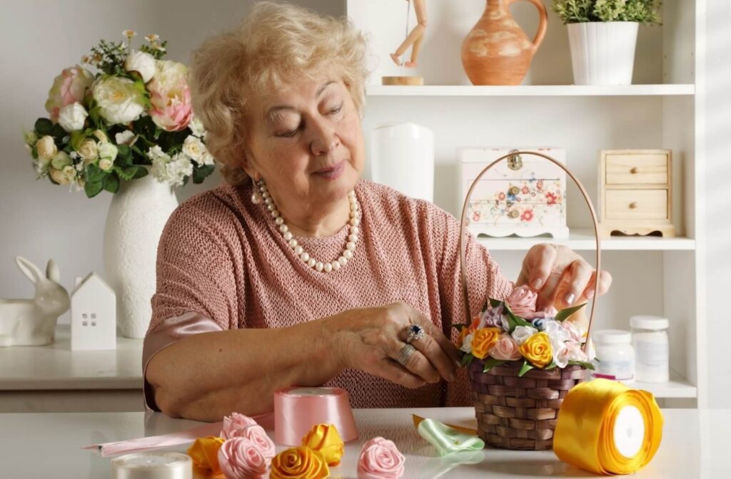 senior with a limited mobility doing a crafts with her hand